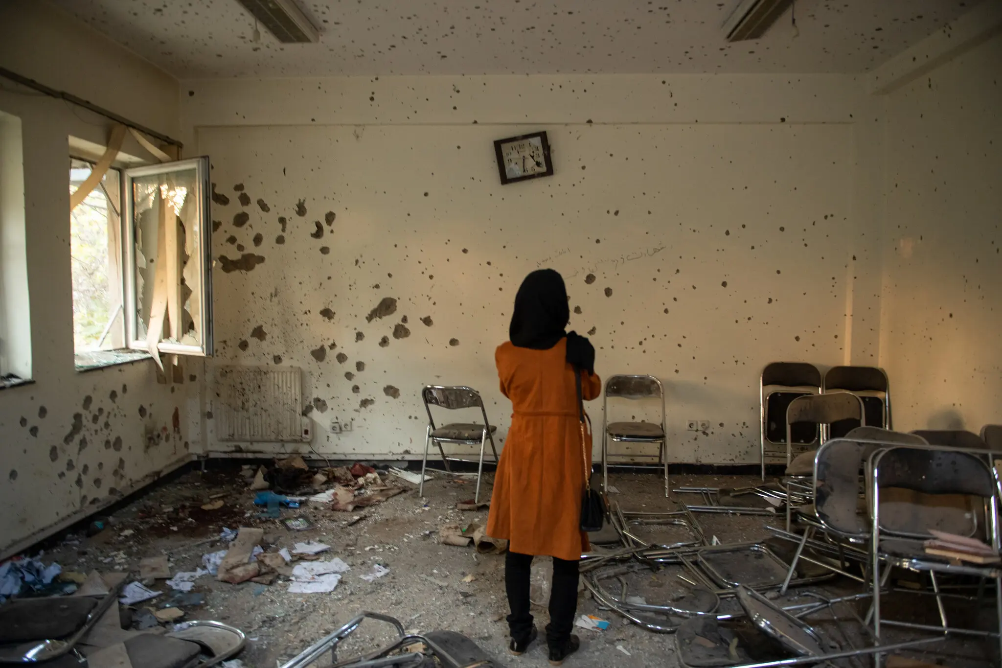 A student looking at the ruins of a classroom at Kabul University, after an ISIS attack that killed 22 students in November 2020. Source: NY Times